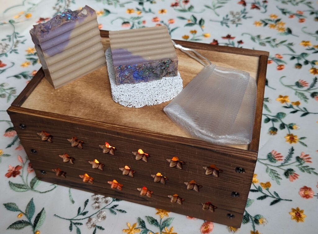 Two Oat Milk and Honey Artisan Soap Bars with white scrub pad and translucent soap bar